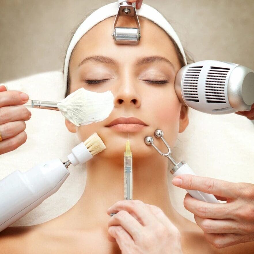 A woman getting her face waxed by four hands.